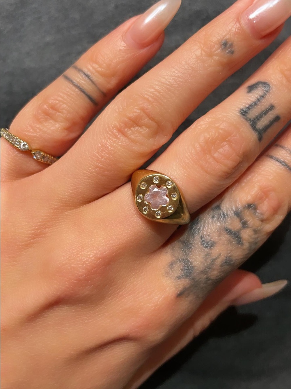 14k signet ring with diamonds and a flower gemstone